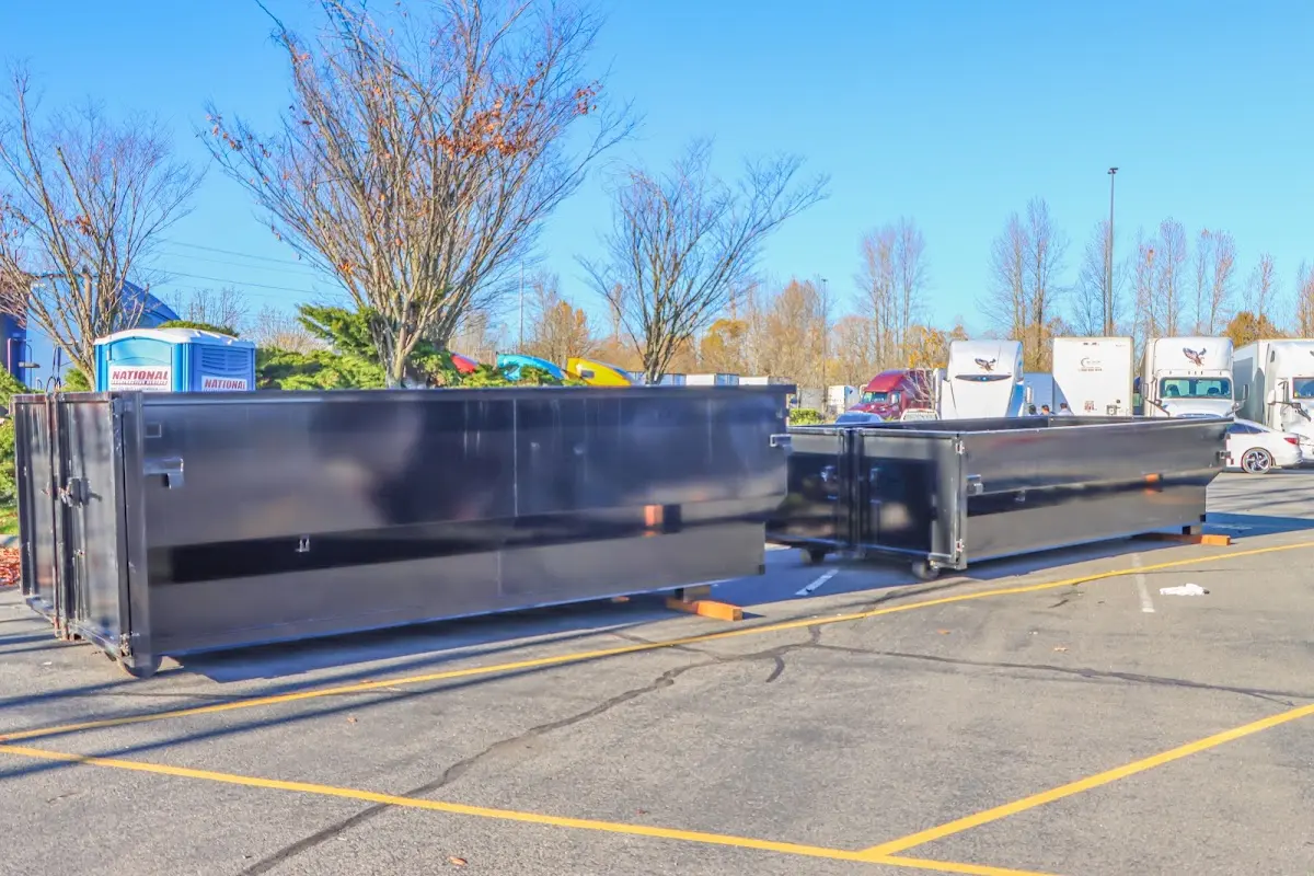 Professional dumpster rental service with roll-off container on residential driveway in Converse